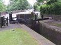 The road widening at Lock 21W which made the tunnel longer also meant that there was no room for a full balance beam on one side so that gate is opened by winding a capstan which operates the gate. (Debdale is down in the lock somewhere! All the locks on the HNC were deep). - Location: Uppermill - Canal: Huddersfield Narrow