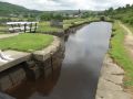 The last nine locks up to the summit are in the Diggle Flight. These are tough and on some locks the ground paddles are very hard work indeed and ideally need two people, each using a windlass on each paddle! Some of the pounds leak and are short of water - especially as you come up thus taking a lock full of water out of the short pound. I was lucky to clear the top cill on my way out here but I heard it touch the underside of the boat. Note the characteristic HNC splayed-sides footbridge. - Location: Diggle - Canal: Huddersfield Narrow