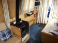The stove and sofa in the forward lounge on Debdale - Location: Great Haywood Marina
